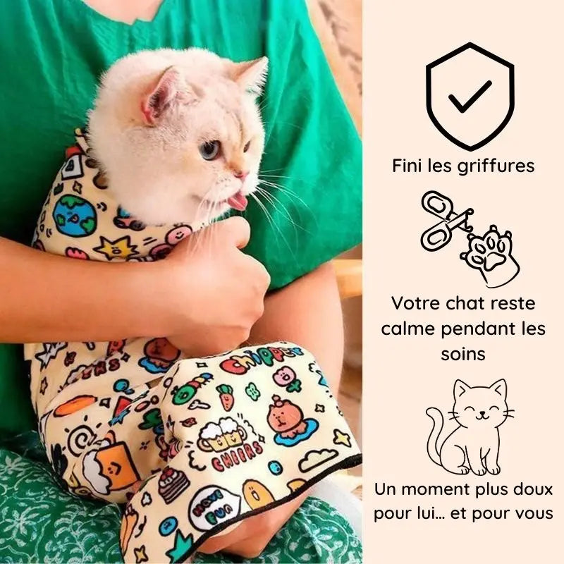 chat blanc enveloppé dans Cocooni pendant le toilettage chat et la coupe des griffes